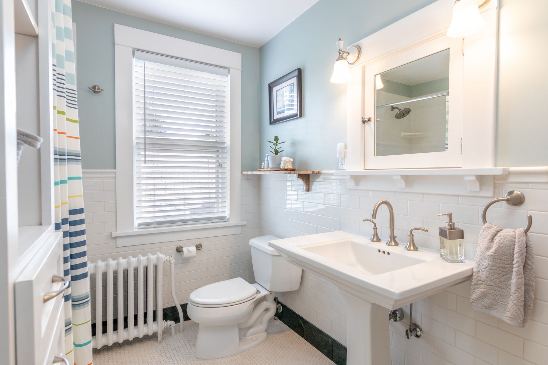 Bright bathroom with white fixtures and clean tile