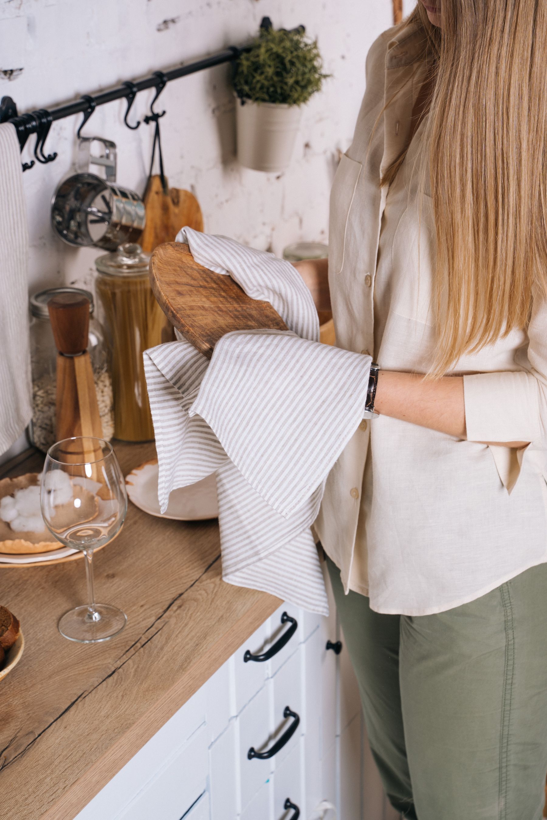 Person carefully wiping a kitchen counter with a cloth